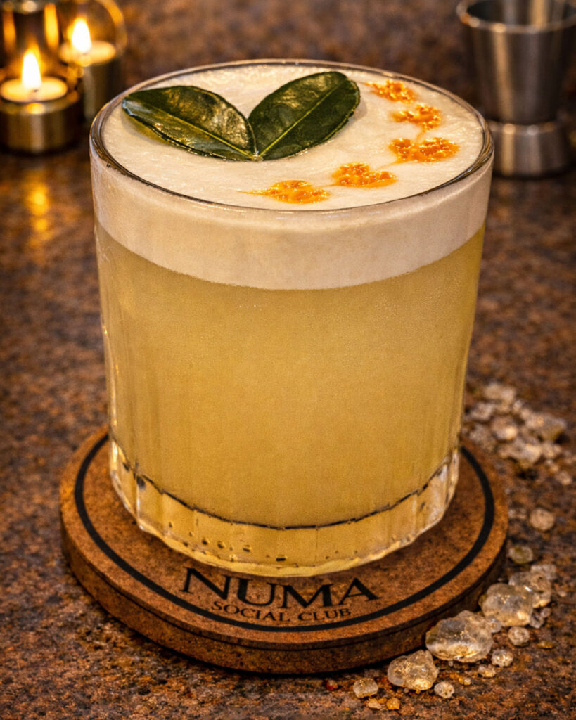 Pico Sour cocktail at Numa Phuket, served with creamy foam and citrus garnish